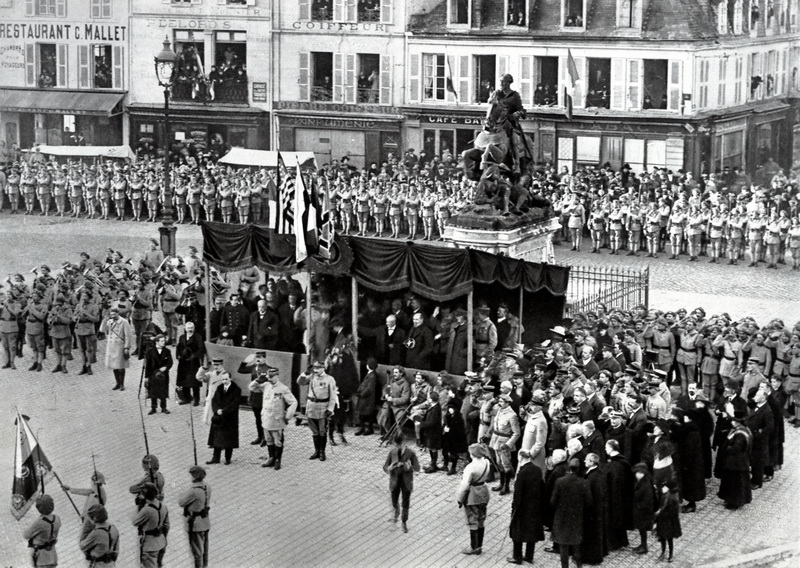Cognac, 26. prosince 1918. Ministr zahraničních věcí E. Beneš (před tribunou v tmavém kabátě) odevzdává prapor 23. čs. střeleckému pluku.