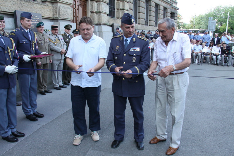 Slavnostní přestřižení pásky - vlevo autor výstavy Jiří Rajlich, uprostřed velitel Vzdušných sil Armády České republiky, brigádní generál Petr Hromek